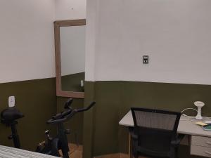 an office with a desk and a chair and a mirror at Studio 102 Cop 30 in Curro Velho