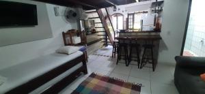 a living room with a couch and a bar at Angel Ilha Flats e Varanda da Praia in Abraão