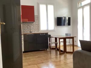 a kitchen and dining room with a table and a kitchen and a table at Agriturismo Il Meroglio in Bordighera +9 photos