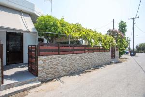 a brick retaining wall with a wooden fence at Gennadi Sea Escape in Gennadi