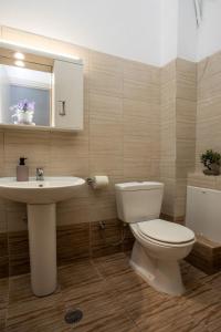 a bathroom with a white toilet and a sink at Gennadi Sea Escape in Gennadi