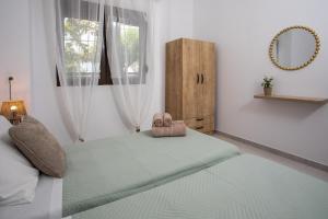 a bedroom with a bed with two towels on it at Gennadi Sea Escape in Gennadi