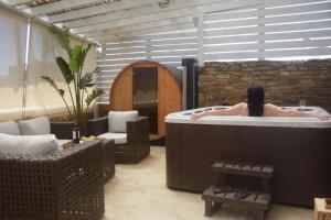 a woman in a bath tub in a room at Renthousetinos 2 in Tinos Town +33 photos