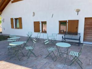 a room with tables and chairs and a bench at Agriturismo Maso San Valentino in San Michele allʼAdige +3 photos