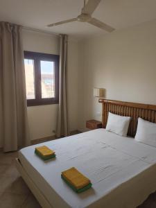 a bedroom with a bed with two towels on it at Marialva Tropical T1 in Santa Maria