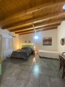 a bedroom with a bed and a wooden ceiling at Monoambiente en posadas 2 in Posadas +9 photos