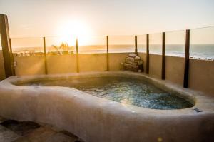 a large bath tub with the ocean in the background at Ankh Jeri in Jericoacoara +91 photos