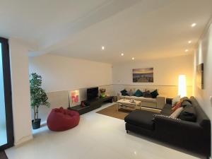 a large living room with a couch and a table at Apartamento "Vila Serena Marisol" in Corroios