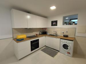a kitchen with a sink and a washing machine at Apartamento "Vila Serena Marisol" in Corroios +12 photos