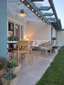 a patio with a table and chairs and a couch at La Casuca del Olivo in Ceceñas