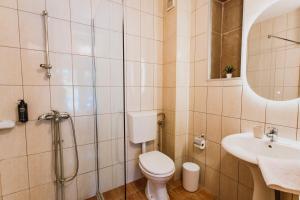 a bathroom with a toilet and a sink at Artelo - Inspired Stay in Bitola
