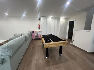 a living room with a couch and a pool table at Loft Puerto Real in Puerto Real +1 photo