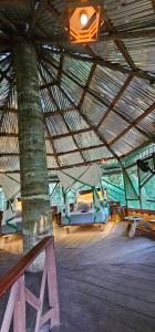 a large wooden building with two beds in it at Casa del árbol - Kiosko el Tacana in Leticia