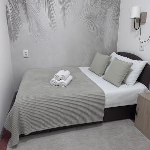 a bedroom with a bed with towels on it at Central Peaceful Nest Belgrade in Belgrade