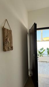a door to a room with a picture on the wall at Casa Vacanza Marijò in Sant'Isidoro