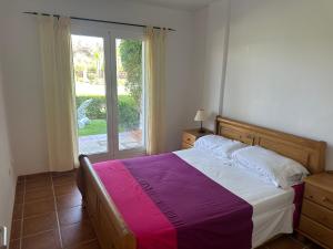 Un dormitorio con una cama grande y una ventana. en Heavenly Homes Mojacar 48, en Mojácar 44 fotos más