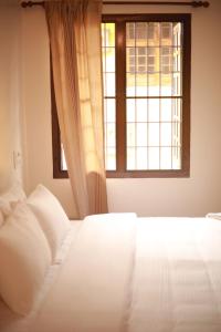 Ένα ή περισσότερα κρεβάτια σε δωμάτιο στο Fort Verdant Homestay