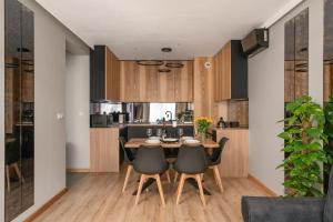 a kitchen and dining room with a table and chairs at Jesionowe Apartamenty nad Odrą, Stare Miasto, Sauna w jednym Apartamencie, Klimatyzacja , Garaż podziemny 0 zł, Odra River , Old Town, New building, Air conditioning, Sauna in one Apt, Underground garage FREE in Wrocław