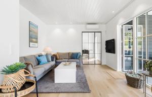 a living room with a couch and a table at Cozy Home In Ebeltoft With Wifi in Ebeltoft