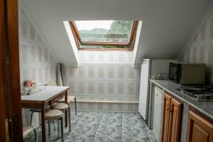 a kitchen with a window and a table and a refrigerator at Pensión San Francisco in Muñera