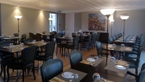 a dining room with tables and chairs and tablesktop at Hotel Medieval® de Penedono in Penedono