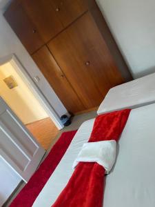 a bed with a red and white blanket on it at two lovers in Vosburg +10 photos