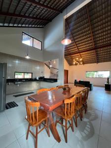 a dining room with a wooden table and chairs at Chale Estação dos Sonhos in Bananeiras