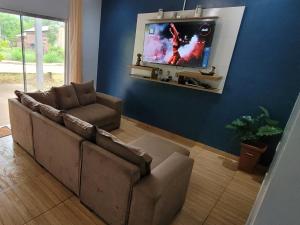a living room with a couch and a flat screen tv at Apartamento de 2 quarto para 6 hóspedes in Oiapoque