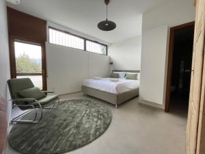 una camera con un letto, una sedia e un tappeto di Villa la Grona a Menaggio