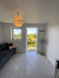 a living room with a couch and a window at Gäst hus in Ystad