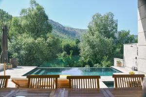 a swimming pool with a view of a mountain at Villa Teja in Mostar +58 photos
