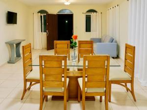 a dining room with a glass table and chairs at Villa Rosa in San Felipe de Puerto Plata +17 photos