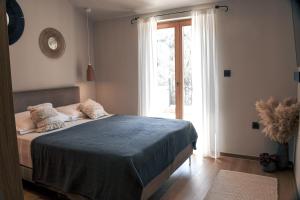 a bedroom with a bed and a large window at Villa Teja in Mostar