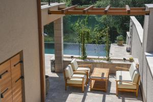 a patio with chairs and a table and a pool at Villa Teja in Mostar