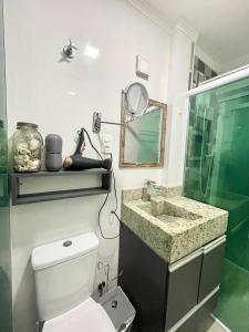 a bathroom with a toilet and a sink and a mirror at Santos Prime Stay in Santos +18 photos