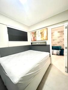 a bedroom with a large white bed in a room at Santos Prime Stay in Santos