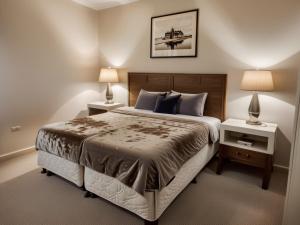 a bedroom with a large bed with two night stands at Modern Venice Beach Stay - Walk to Marina & Boardwalk in Los Angeles