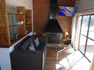 a living room with a couch and a fireplace at Hostería de los Césares in Merlo +27 photos