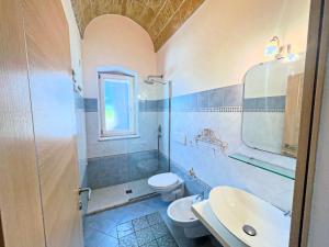a bathroom with a toilet and a sink and a shower at Casa delle sorgenti in Torre Vado