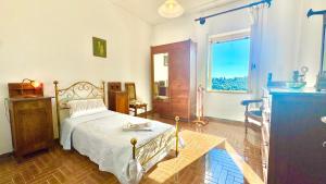 a bedroom with a bed and a window at Casa di Nonna in Montefranco