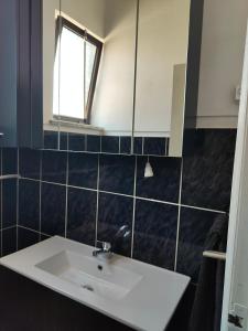 a bathroom with a white sink and a window at Mustachos's Home  +19 photos