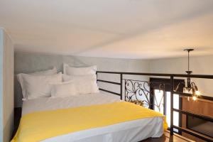 a bedroom with a yellow and white bed on a balcony at LOFT LAPA Baldô in Rio de Janeiro