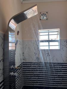 a shower with water coming out of the ceiling at Kristina Gardens in Voi