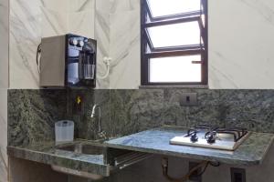 a kitchen counter with a stove and a sink at LOFT LAPA Baldô in Rio de Janeiro +11 photos
