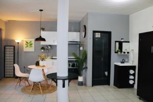 a kitchen and dining room with a table and chairs at Preciados Loft Cold AC best WIFI in Tequila