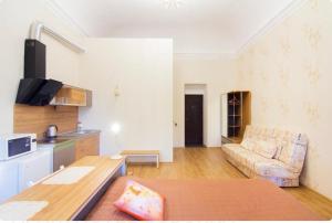 a kitchen and living room with a couch and a table at Апартаменты на Соборной площади центр in Odesa