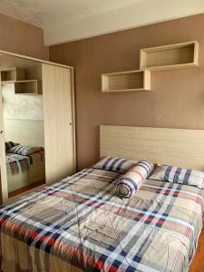 ein Schlafzimmer mit einem Bett und zwei Etagenbetten in der Unterkunft Margonda Residence 5 Depok by Sahaja Stay in Kemirimuka Tiga