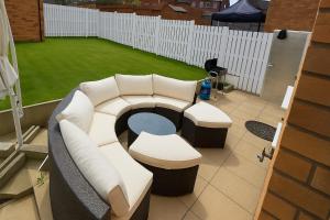 a room with a couch and a table and a grass field at Rosengelyn Apartment in Sheffield