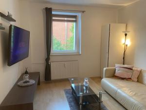a living room with a couch and a table at Cozy Apartment in Cologne Center in Cologne
