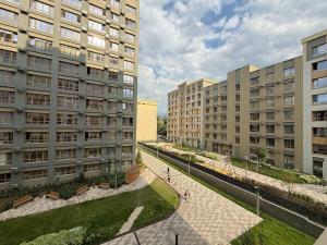 a view of two tall buildings in a city at Уютная в центре города in Zhezdi